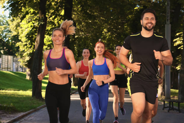 istock Group of people running in park. Active lifestyle 1932568557