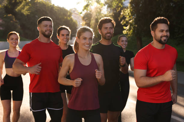 istock Group of people running outdoors on sunny day 1932569078