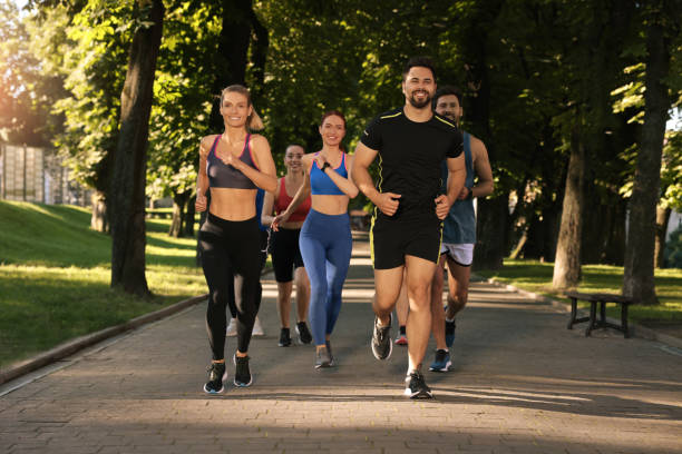 istock Group of people running in park. Active lifestyle 1932569090