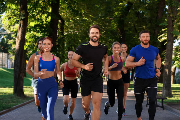 istock Group of people running in park. Active lifestyle 1932569627