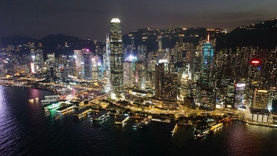 Drone shot over Victoria Harbour in Central Hong Kong by night