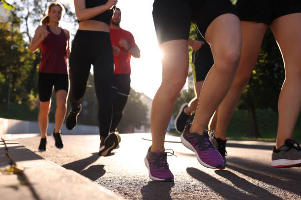 istock Group of people running outdoors on sunny day, closeup view 1932571269