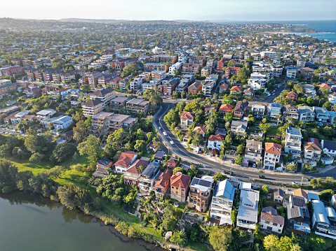 An aerial view of a picturesque residential neighborhood nestled alongside a serene body of water