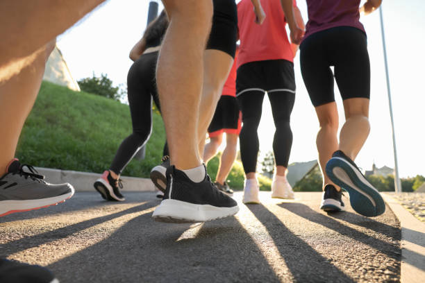 istock Group of people running outdoors on sunny day, closeup 1932574472