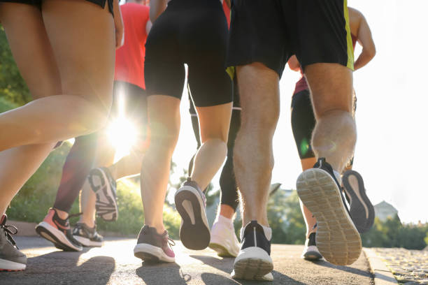 istock Group of people running outdoors on sunny day, closeup 1932574479