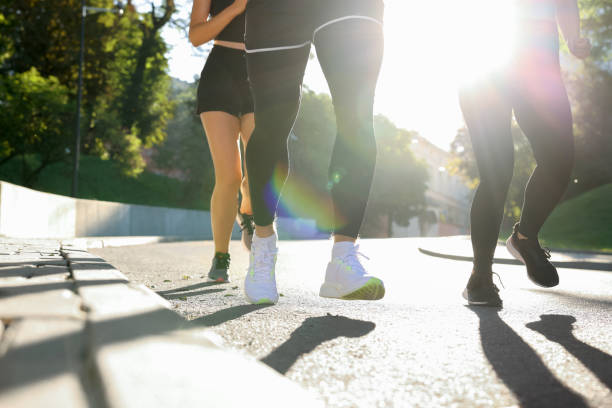 istock Group of people running outdoors on sunny day, closeup 1932574481