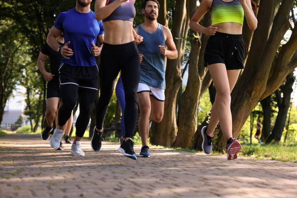 istock Group of people running in park on sunny day 1932582509