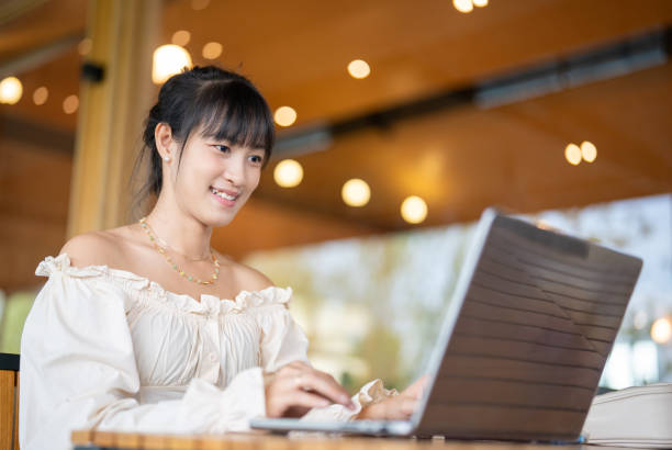 istock Young Asian Woman's Remote Office in coffee shop. 1932607456