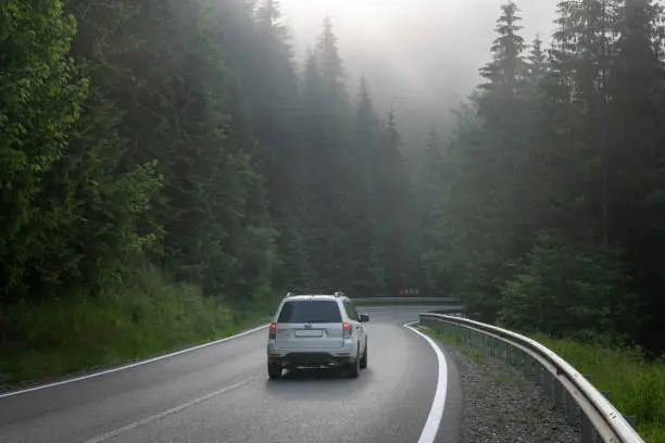 Carpathian mountains, Ukraine - June 2021: Road trip, Subaru Forester on the road in forest