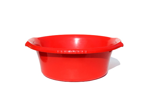 A red plastic basin stands on a white background.