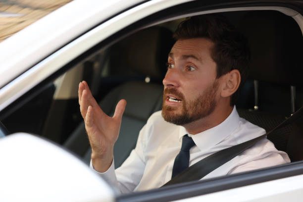 istock Stressed driver in his car, view from outside. Stuck in traffic jam 1932631252