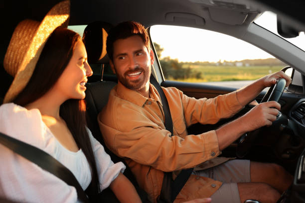istock Happy couple enjoying trip together by car 1932632294