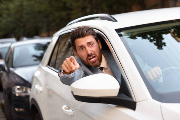 istock Angry driver screaming at someone from car in traffic jam 1932632785