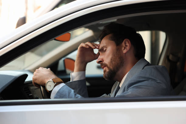 istock Stuck in traffic jam. Stressed driver in his car, view from outside 1932632818