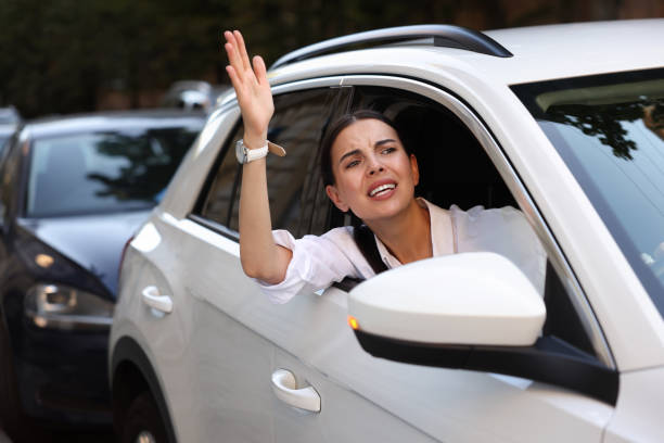 istock Angry driver screaming at someone from car in traffic jam 1932633352