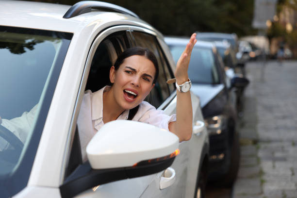 istock Angry driver screaming at someone from car in traffic jam 1932633353
