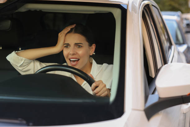 istock Stuck in traffic jam. Angry driver in her car, view through windshield 1932636000