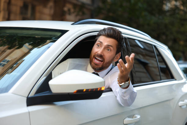 istock Angry driver screaming at someone from car in traffic jam 1932636530