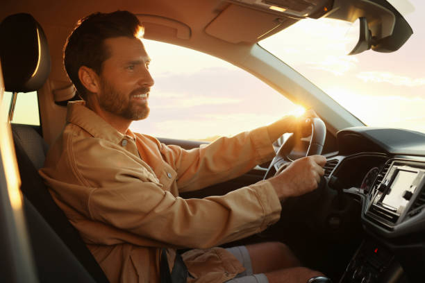 istock Happy bearded man sitting in his car. Enjoying trip 1932637070
