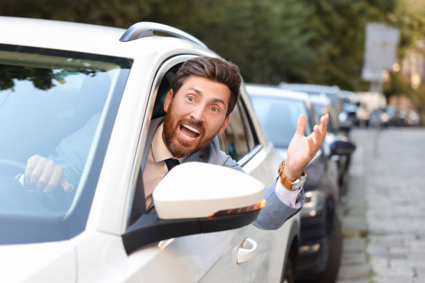 istock Angry driver screaming at someone from car in traffic jam 1932638129
