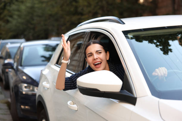 istock Angry driver screaming at someone from car in traffic jam 1932638137