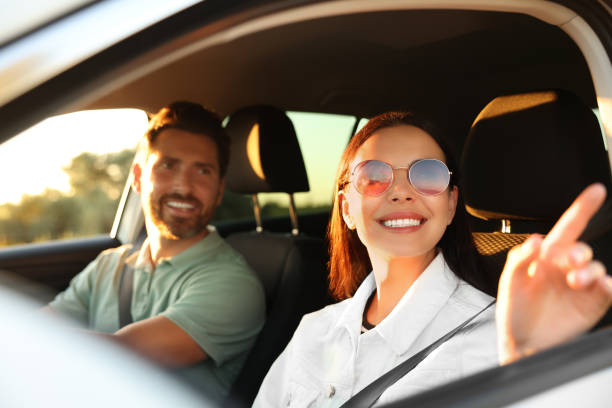istock Happy couple enjoying trip together by car, selective focus 1932638689