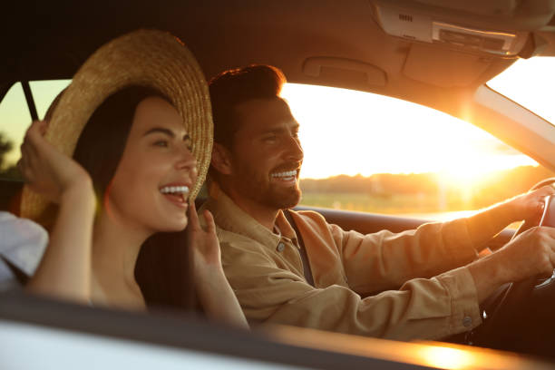 Happy couple enjoying trip together by car, selective focus