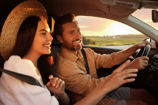 istock Happy couple enjoying trip together by car 1932639740