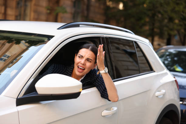 istock Angry driver screaming at someone from car in traffic jam 1932642429