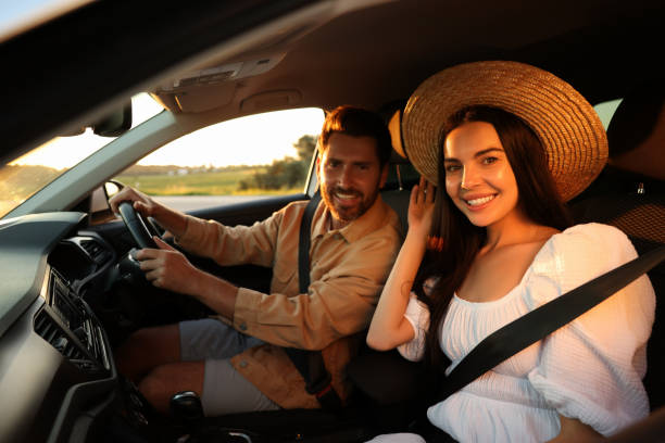 istock Happy couple enjoying trip together by car 1932647248