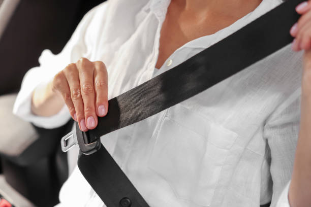 istock Woman pulling seat belt in car, closeup 1932649960