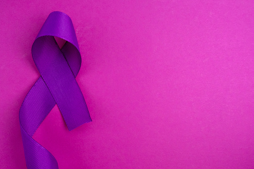 International Epilepsy Day. Purple ribbon on a color background. Alzheimer's disease, pancreatic cancer, Hodgkin's lymphoma awareness. copy space. September 21. World Lupus Day