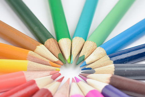 Seamless coloured pencils lying in a circle Close Up Photographed with selective focus On white background
