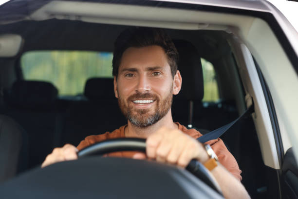 istock Enjoying trip. Happy bearded man driving car, view through windshield 1932660711