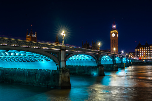 Bridge illuminated, illumination and river, reflection of bridge on water surface.