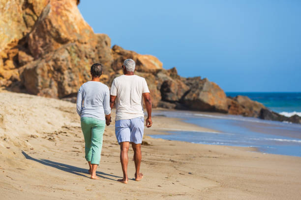 istock Senior African American couple walking on beach 1932681087