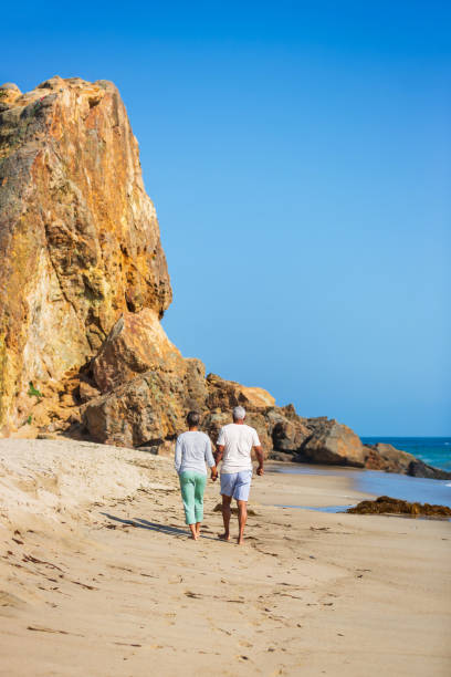 istock Senior African American couple walking on beach 1932681663