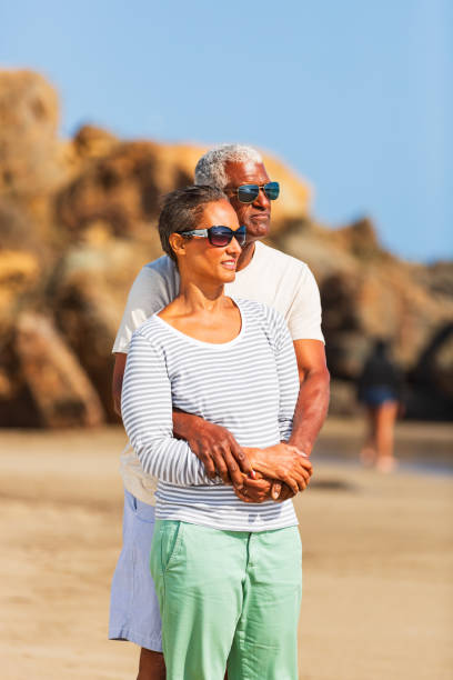 istock Senior African American couple embracing on beach 1932684348