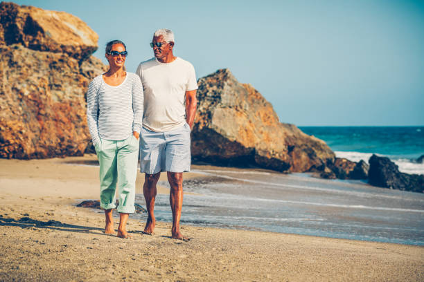istock Senior African American couple walking on beach 1932687644
