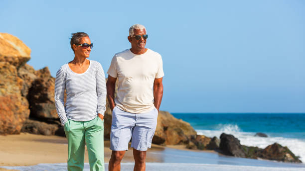 istock Senior African American couple walking on beach 1932688675