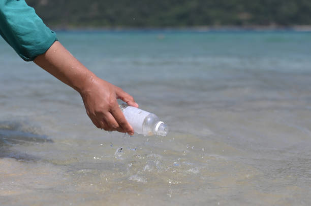 istock Picking up bottle trash from the sea 1932688687