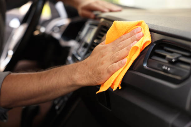istock Man cleaning car interior with rag, closeup 1932711873