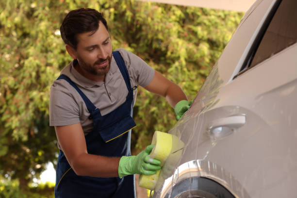 istock Worker washing auto with sponge at outdoor car wash 1932715725