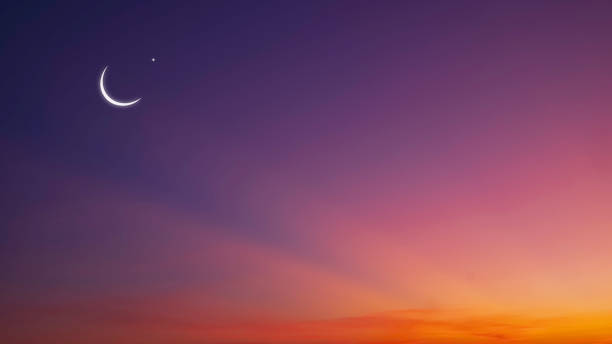 istock Crescent Moon and Star on dramatic Twilight Sky with colorful majestic light on Night Sky Background 1932723848