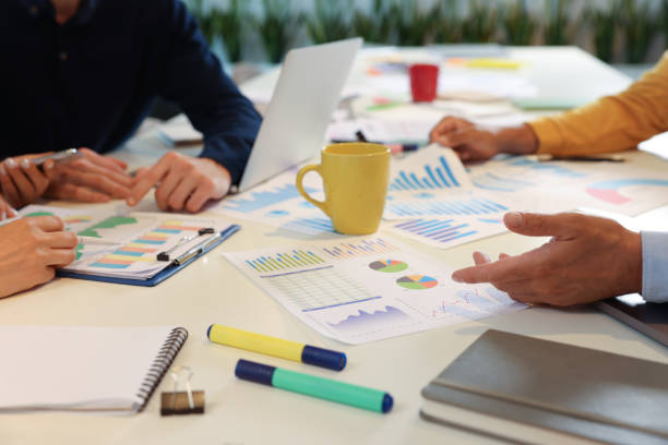istock Team of employees working with charts at table, closeup. Startup project 1932737434