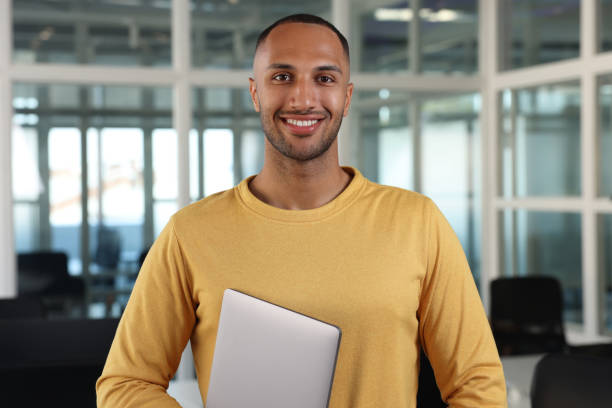 istock Handsome happy man with laptop in office 1932737945