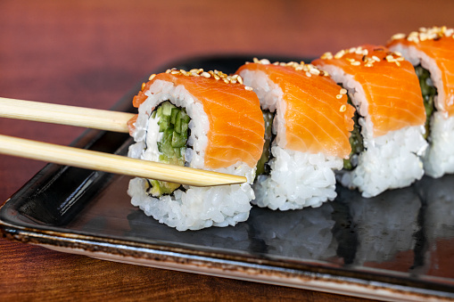 Sushi roll Philadelphia with red fish. Salmon sushi.