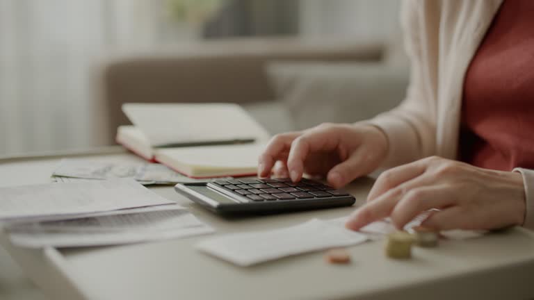 Close-up Total all of monthly household expenses. Woman counts finances for family