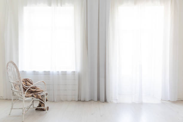 Simple background looking through hotel room curtains, with defocussed buildings in the background Shadows and Light on a Window Curtain