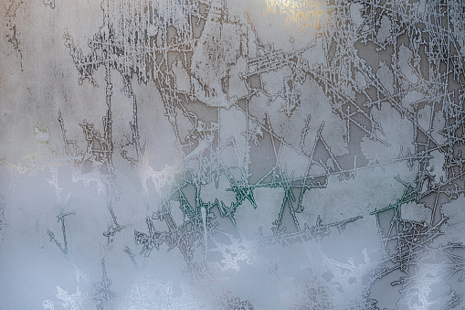 window glass covered with ice and frost. ice pattern on glass. High quality photo